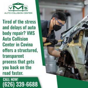 A VMS Auto Collision Center technician in Covina using specialized tools to repair a car's body, highlighting their structured and transparent repair process.