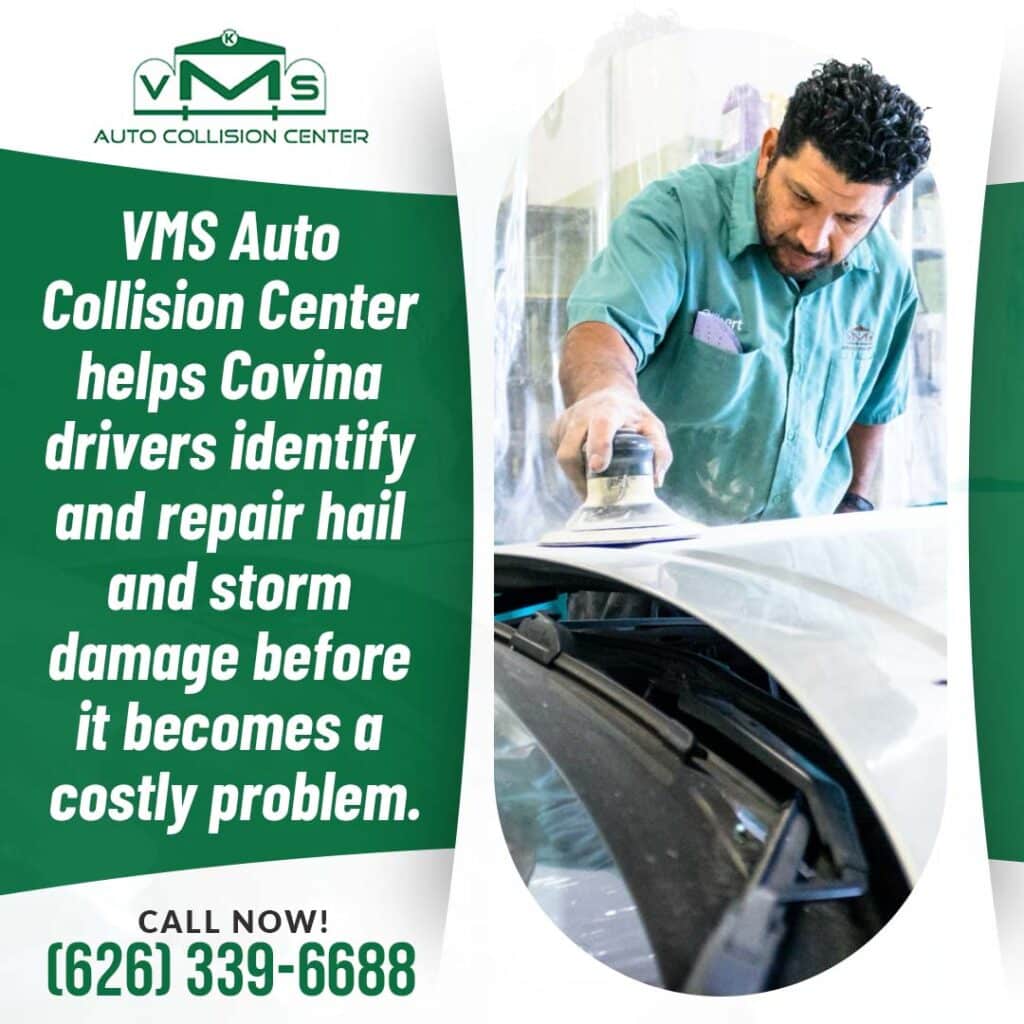 Technician sanding and repairing car surface after hail and storm damage at auto body shop